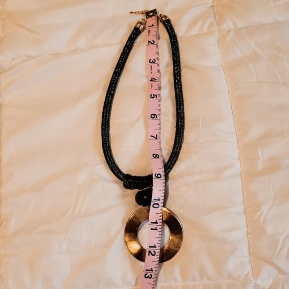 Black rope necklace with gold medal, black, and gray circle. - Picture 5 of 6